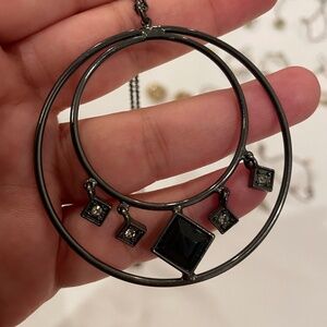 Elegant black necklace with intricate design.